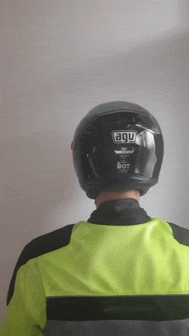 why do motorcyclists tap their helmet